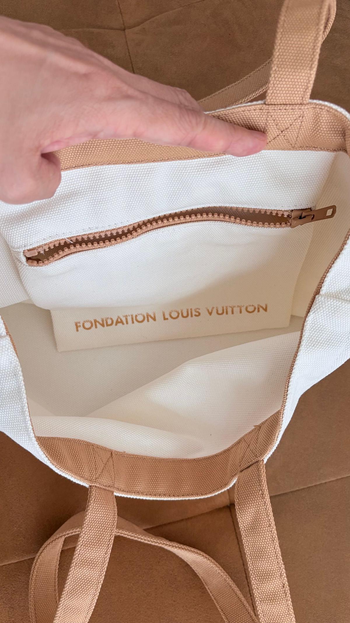 内ポケット付きのトートバッグ。内側のポケットには「Fondation Louis Vuitton」のロゴがプリントされている。バッグ本体は白地にベージュの縁取り、持ち手はベージュ。