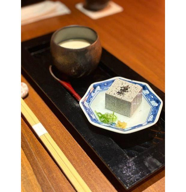 木製のトレーに、和風の器に入った白い飲み物、青と白の模様の皿に乗った豆腐、箸が置かれている。