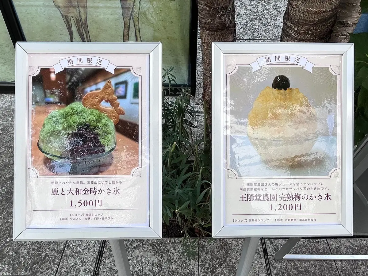ショーケースに並んだ、期間限定の動物モチーフのケーキ2点。左は鹿と大和金時少々水羊羹、右は王配堂農園完成梅の少々水。それぞれ価格表示あり。背景には動物のオブジェが置かれている。