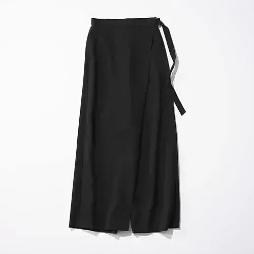 黒いラップスカート。ミモレ丈で、ウエストに細いベルトが巻かれている。シンプルなデザインで、光沢のない素材。