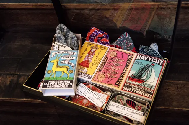 大きめのマッチ箱のようなボックスやブリキの缶に入ったしゃれたデザインのバンダナ（各€35）は、旅の記念やプレゼントによさそう