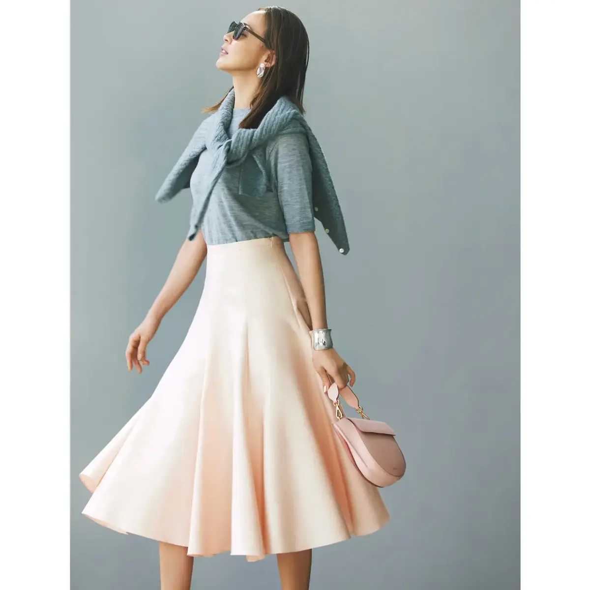 可憐なピンクスカートはクールなグレーニットと合わせて大人好みの微糖モードに仕上げて。