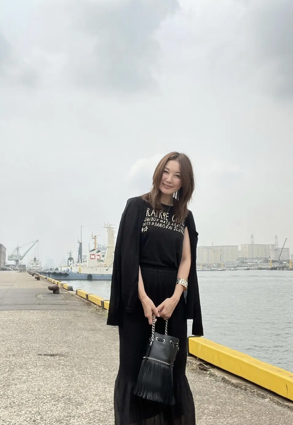 港　コンビナート　ブラックコーデの女性一人