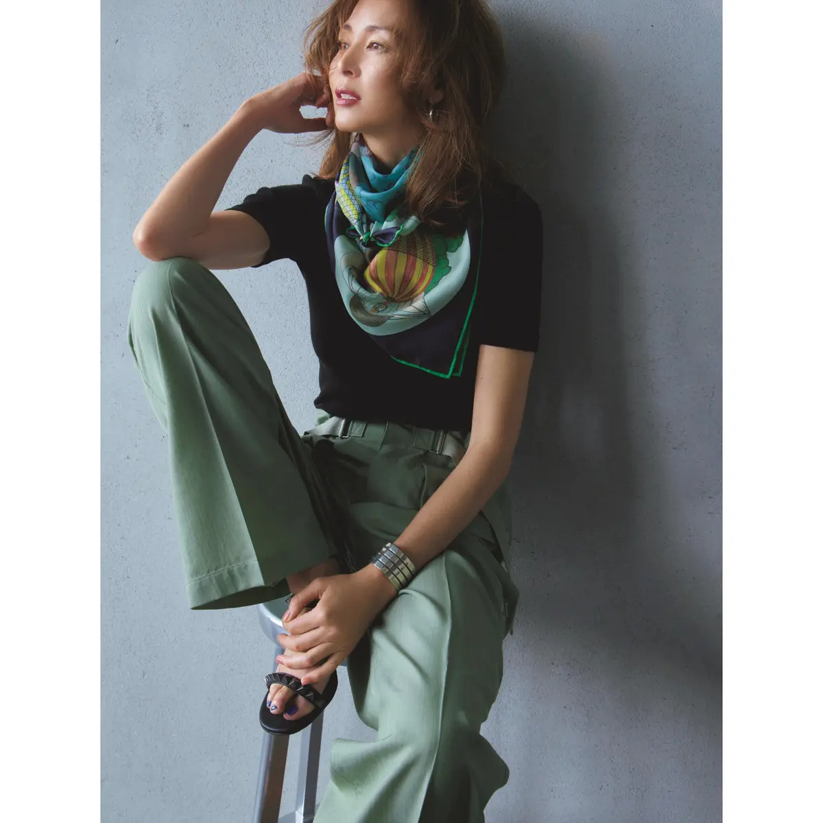 黒Tシャツの首元にプリントスカーを巻き、カーキパンツを合わせたコーディネート　モデル・SHIHO