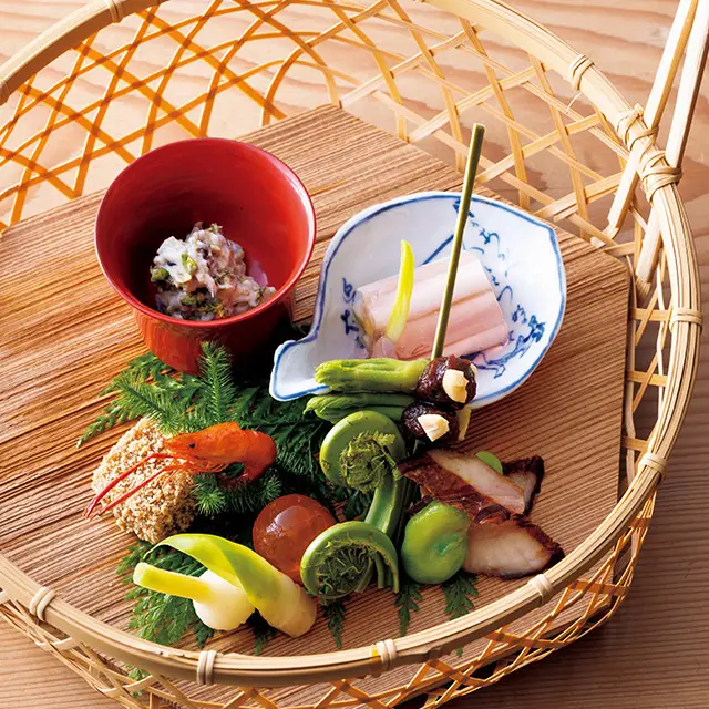 ふきのとう白あえ、うるい甘酢ゼリー寄せ、タラの芽田楽、のびる甘酢漬けなどを盛った「菜籠」