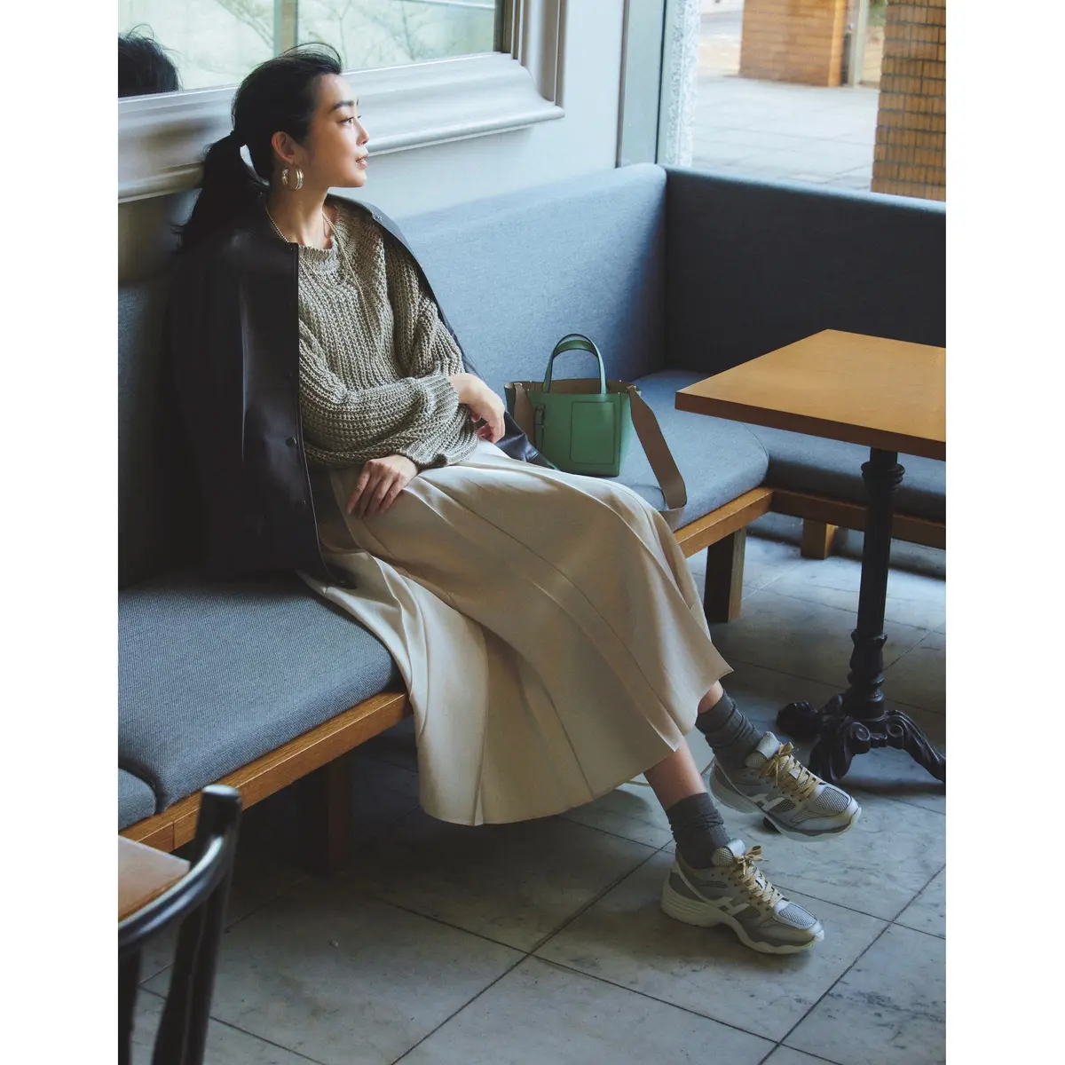 黒ブルゾンとカーキニット、ベージュプリーツスカートのコーデ　モデル・ゆうき