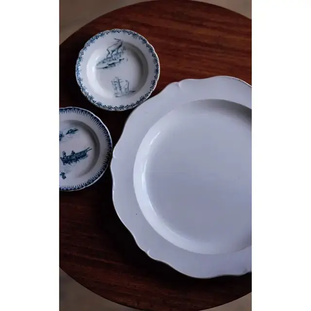 温かみのある乳白色の皿はフランス・モントレの1800年代のもの￥22,000。ほぼ同時期の器で、フランスに行ったときに手に入れた絵がわりの小皿はおままごとに使われていたもの。各￥6,000