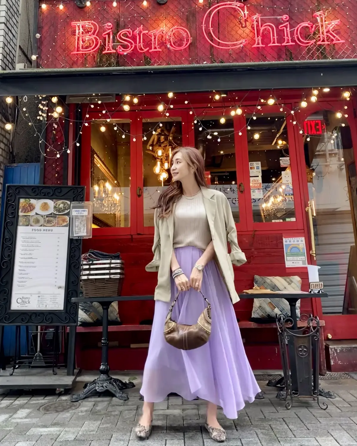 サンドベージュのジャケットとトップスにラベンダーカラーのスカート