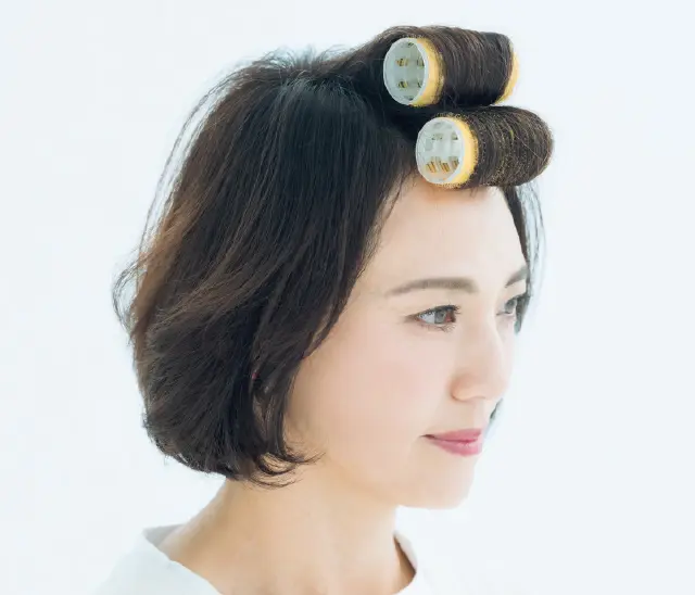 長短の毛束をカーラーで巻いて根元を立ち上げ