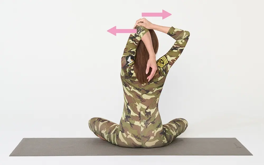 OurAge×Webエクラ　① 左のひじを上げて後頭部につけて曲げ、右手をひじに当てて引き寄せ、ひじと手で押し合うようにします。同時に頭と、つけたひじでも押し合うようにします。