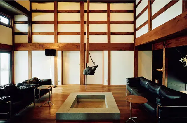 あちこちに美術館級の名作チェアが。中央に囲炉裏のある広々とした吹き抜けのリビングには、ル・コルビジェのLC3も