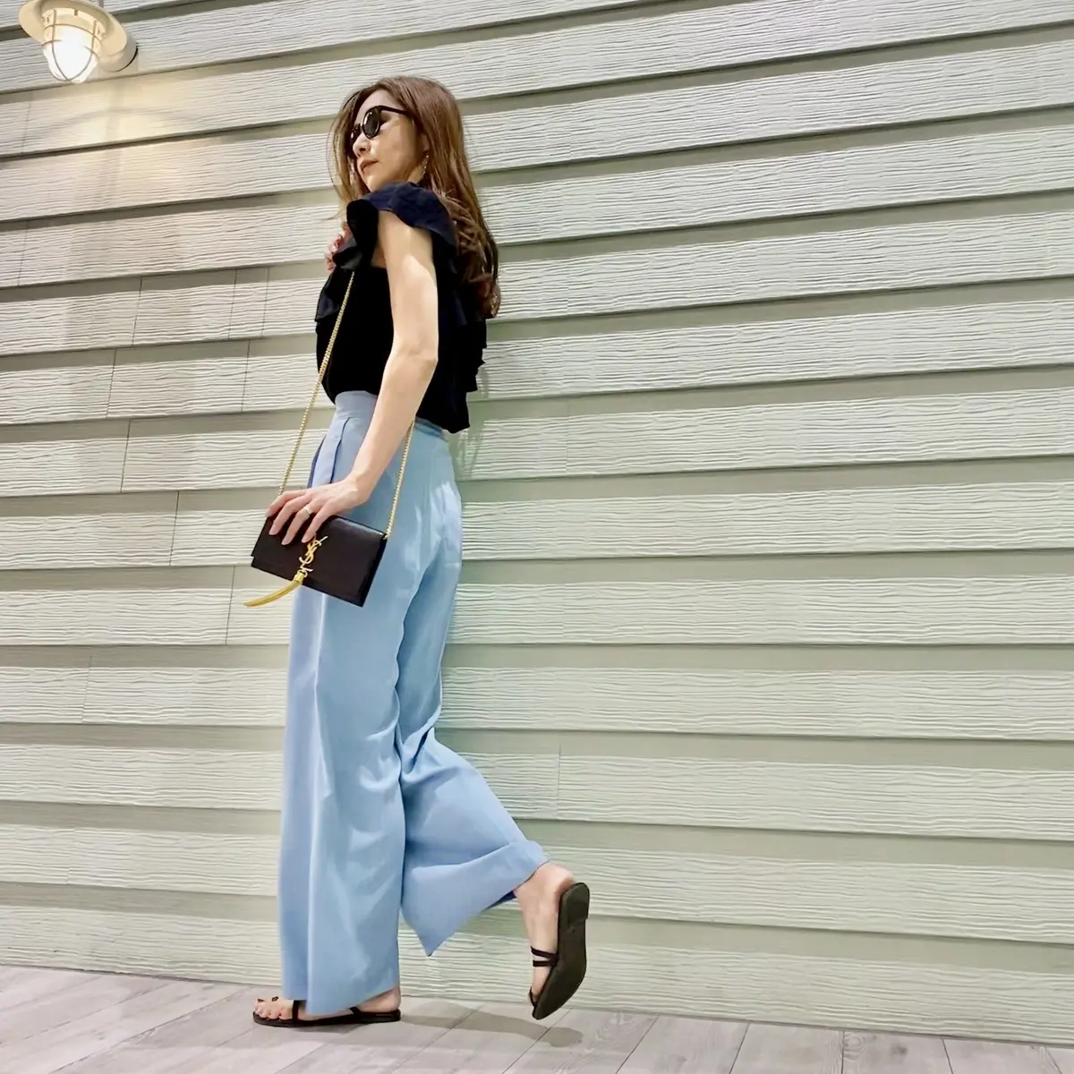 水色ワイドパンツと黒のフリルブラウスコーデの横向き