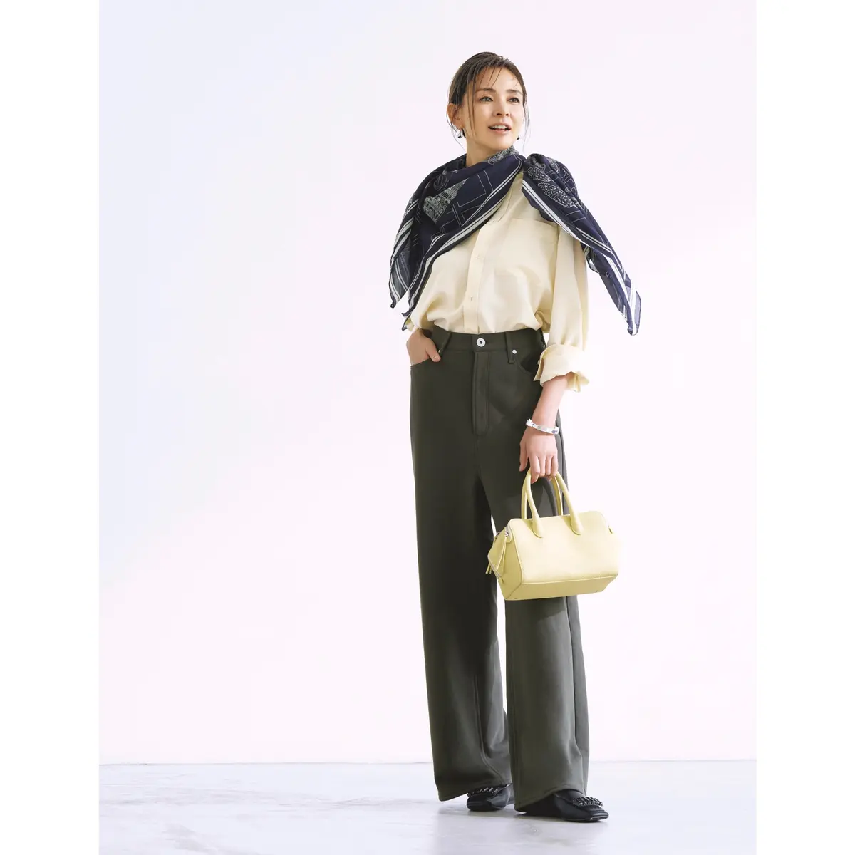 クリームシャツとグレーパンツの組み合わせに、首にネイビースカーフを巻いたコーディネート　モデル・SHIHO