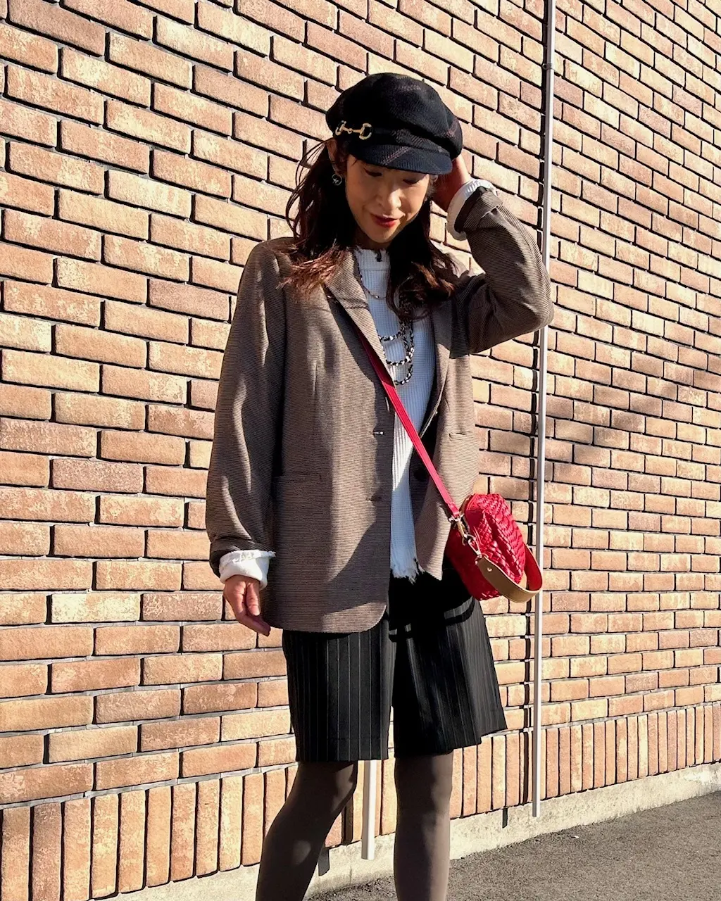 無印良品のブラウンジャケットに赤いバッグの画像_1