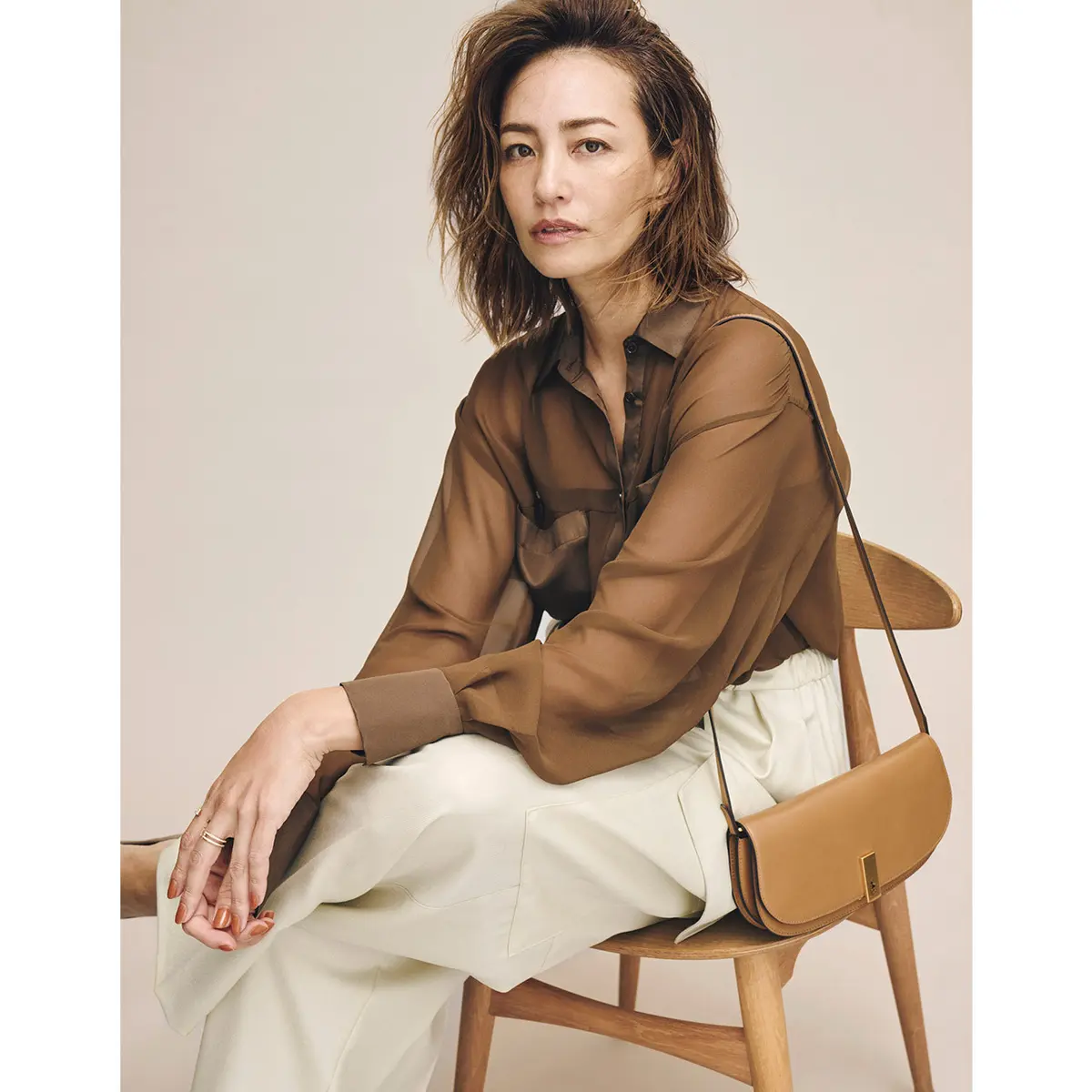 ブラウンシアーシャツとオフ白パンツのコーデを着たモデル・RINA