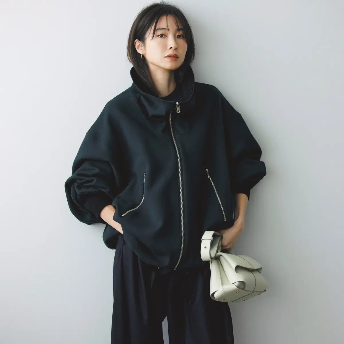 黒スタンドカラージップアップジャケットにゆるパンツを合わせたコーディネート　モデル・絵美里