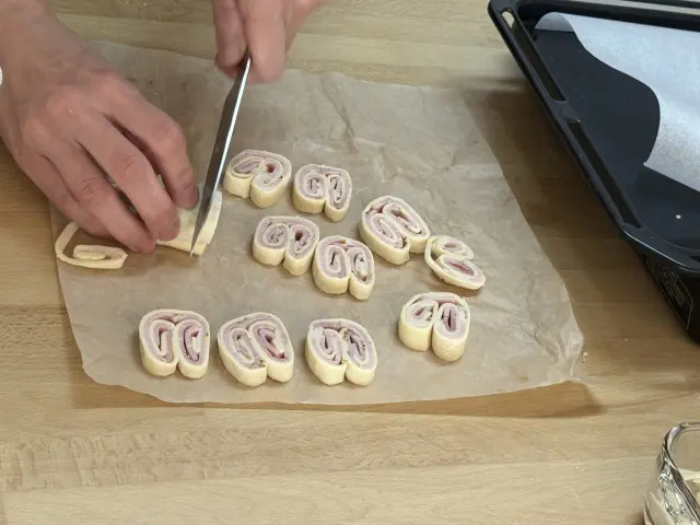 ハムのパルミエ、市販のパイシートにマスタードとハムを乗せて源氏パイの様に丸めて、あとはカットするだけ。