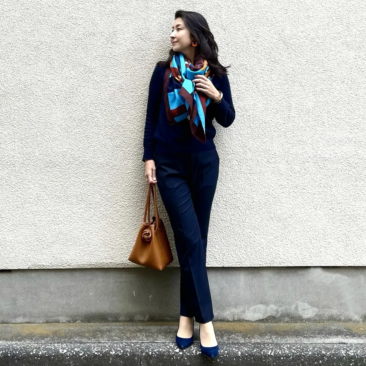ネイビーニット、ネイビーストレートパンツ、ネービーパンプス、スカーフ柄大判ストール、キャメルの小さめバッグ
