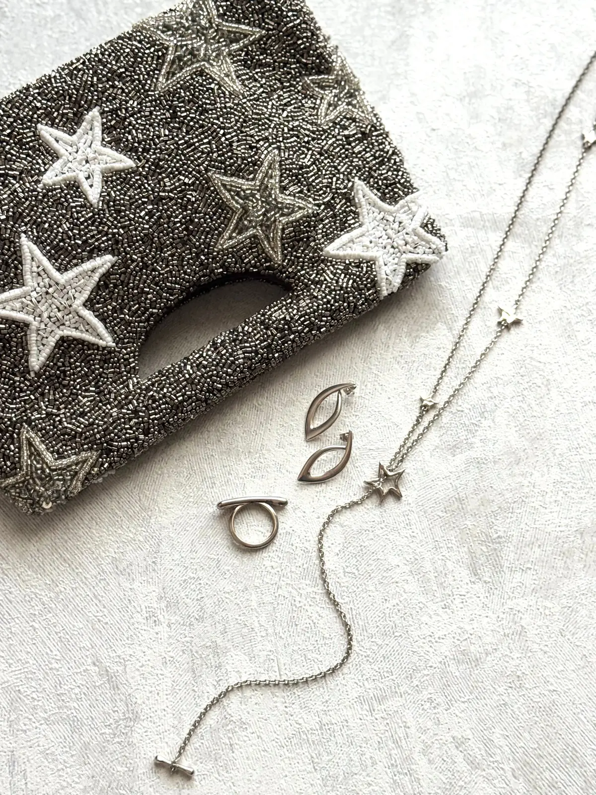 星模様の刺繍パッチと星型チャームのシルバーチェーン、リング、イヤリングが並ぶジュエリーセット
