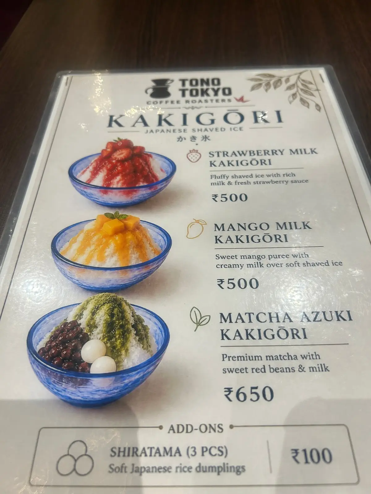 Tono Tokyoの「KAKIGORI」メニュー。上から、イチゴミルク、マンゴーミルク、抹茶あずきのかき氷の写真が並ぶ。それぞれに価格と説明文が記載。下部には、白玉（3個）の追加オプションと価格がある。